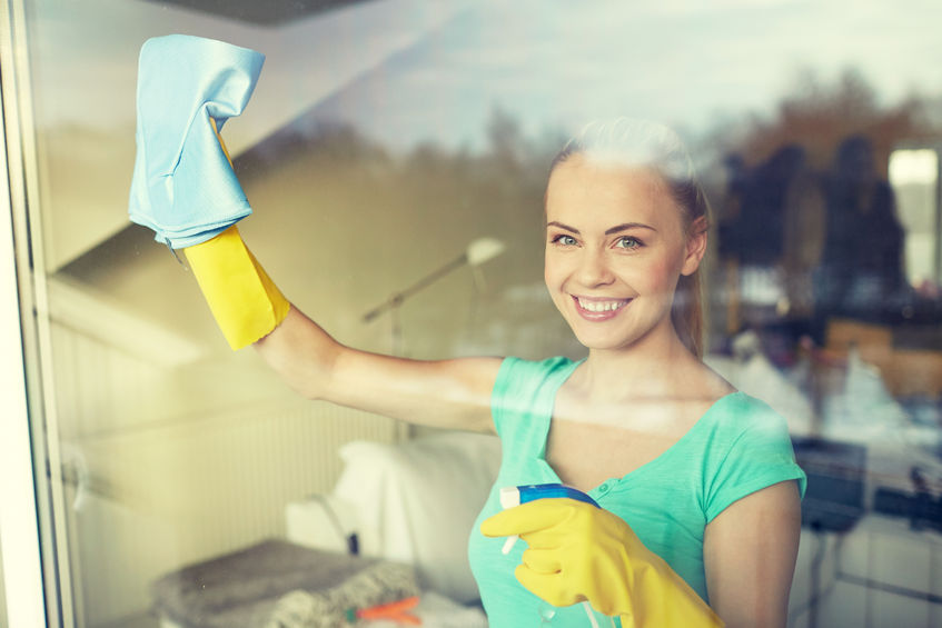 51129855 - people, housework and housekeeping concept - happy woman in gloves cleaning window with rag and cleanser spray at home