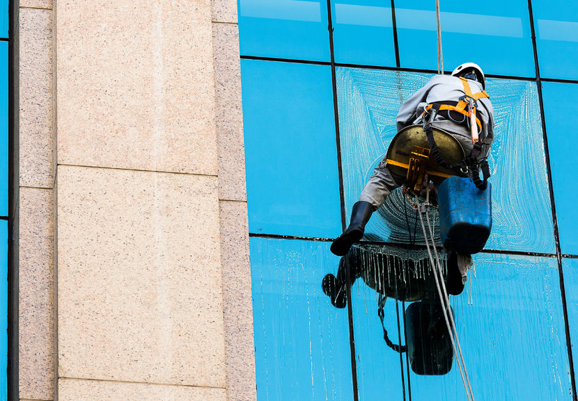 52319951 - so paulo, brazil, january 31, 2015. worker cleaning windows of a commercial building on january 31, 2015 in sao paulo, brazil.