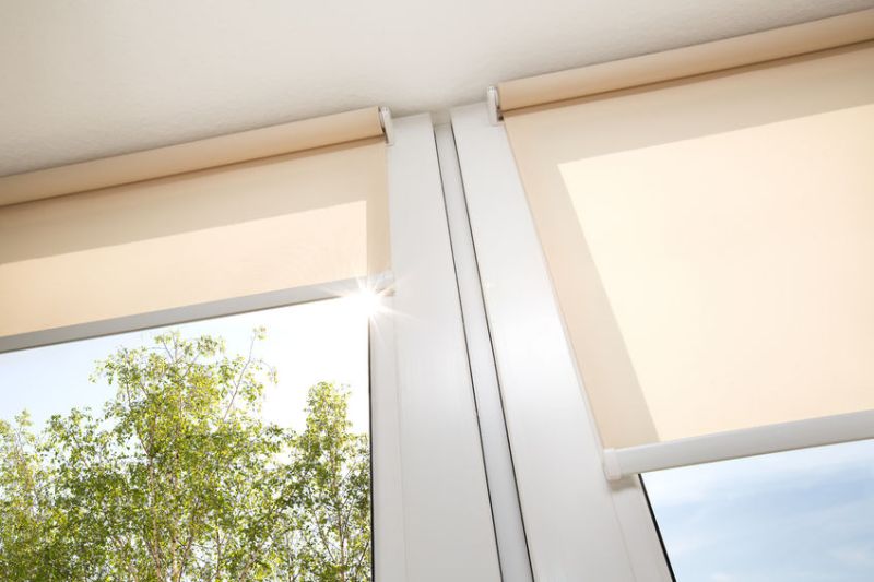 46316147 - window with sand coloured roll blinds